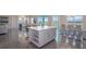 Open-concept space with a kitchen island, dining area, and living room beyond at 4731 Clock Tower Dr # 401, Kissimmee, FL 34746