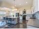 Spacious kitchen with stainless steel appliances, island with seating, and elegant lighting at 4731 Clock Tower Dr # 401, Kissimmee, FL 34746
