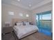 Spacious bedroom with a large bed, bedside tables, tray ceiling and sliding glass doors to the balcony at 4731 Clock Tower Dr # 401, Kissimmee, FL 34746