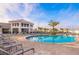 Community pool features lounge chairs, a modern poolhouse, and a resort-style atmosphere at 4731 Clock Tower Dr # 401, Kissimmee, FL 34746