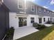 Rear exterior showing a white concrete patio with sliding glass doors leading to a yard at 5108 Rain Shadow Dr, St Cloud, FL 34772