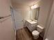 Bright bathroom featuring a vanity with modern fixtures, and wood-look tile floors at 5108 Rain Shadow Dr, St Cloud, FL 34772