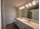 Well-lit bathroom with double sinks, quartz countertop, and a spacious glass shower at 5108 Rain Shadow Dr, St Cloud, FL 34772