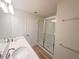 Bright bathroom featuring double sinks, quartz countertop, and a glass enclosed shower at 5108 Rain Shadow Dr, St Cloud, FL 34772