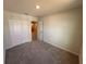 Bedroom with carpet flooring, a closet and a view into the hallway at 5108 Rain Shadow Dr, St Cloud, FL 34772
