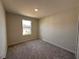 Small bedroom featuring neutral carpet, natural light from window and neutral paint at 5108 Rain Shadow Dr, St Cloud, FL 34772