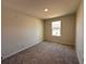 Cozy bedroom with neutral carpet, natural light from window and neutral paint at 5108 Rain Shadow Dr, St Cloud, FL 34772