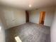 Bedroom with carpet flooring and doorways into the hallway and bathroom at 5108 Rain Shadow Dr, St Cloud, FL 34772