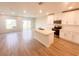 Bright, modern kitchen featuring white cabinetry, stainless steel appliances, a center island, and wood-look tile floors at 5108 Rain Shadow Dr, St Cloud, FL 34772
