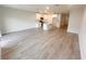 Open-concept living room and kitchen with modern appliances, an island, white cabinetry and tile flooring at 5108 Rain Shadow Dr, St Cloud, FL 34772