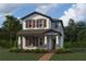 Two-story home with gray siding, brown shutters, and a covered front porch at 5306 Center Lake Ranch Blvd, St Cloud, FL 34771