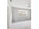 Well-lit bedroom with neutral walls, white trim, ceiling fan and large window at 5413 Hansel Ave # K10, Orlando, FL 32809