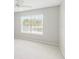 Bright bedroom featuring a large window offering plenty of natural light and a ceiling fan for comfort at 5413 Hansel Ave # K10, Orlando, FL 32809