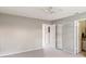 Spacious bedroom with neutral walls and carpet, ceiling fan and two closets at 5413 Hansel Ave # K10, Orlando, FL 32809