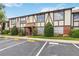 Tudor-style condo building with well-manicured landscaping and convenient parking lot in front at 5413 Hansel Ave # K10, Orlando, FL 32809