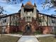 Brick building exterior with turrets and a courtyard entrance at 5413 Hansel Ave # K10, Orlando, FL 32809