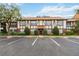 Condo exterior showcases Tudor-style architecture, well-maintained landscaping, and convenient parking at 5413 Hansel Ave # K10, Orlando, FL 32809