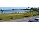 Beautiful lake view featuring green space with palm trees, benches, and boat docks at 5413 Hansel Ave # K10, Orlando, FL 32809
