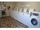 On-site laundry room with multiple clean, modern washing machines for resident convenience at 5413 Hansel Ave # K10, Orlando, FL 32809