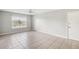 Bright, spacious living room featuring tile floors, a ceiling fan, and large window with natural light at 5413 Hansel Ave # K10, Orlando, FL 32809