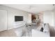 Bright living room with tile floors, ceiling fan, modern furniture, and open access to the dining area at 5413 Hansel Ave # K10, Orlando, FL 32809