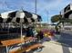 Outdoor patio with picnic tables and umbrellas, offering a relaxing space at 5413 Hansel Ave # K10, Orlando, FL 32809