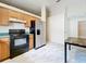 Kitchen boasts wood cabinets, stainless steel appliances, and tiled floors at 5633 Piney Ridge Dr, Orlando, FL 32808