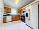 Bright kitchen with wood cabinets, stainless steel fridge, and tiled floor at 5633 Piney Ridge Dr, Orlando, FL 32808