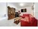 Living room with red sectional sofa, wooden coffee table, and entertainment center at 5633 Piney Ridge Dr, Orlando, FL 32808