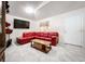 Living room featuring a red sectional sofa and large TV at 5633 Piney Ridge Dr, Orlando, FL 32808