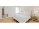 A bright and well-lit bedroom with a large bed and wood-look flooring at 6618 Sw 128Th Pl, Ocala, FL 34473