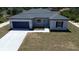 Inviting single-story home featuring a pristine driveway and attached garage at 6618 Sw 128Th Pl, Ocala, FL 34473