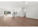 Open-concept living room with hardwood floors seamlessly connected to the modern kitchen at 6618 Sw 128Th Pl, Ocala, FL 34473