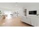 Modern living area with an open floor plan connecting the kitchen, dining, and living spaces with bright lighting at 6618 Sw 128Th Pl, Ocala, FL 34473