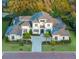 Expansive aerial view showcases the home's sprawling layout, manicured lawn and landscaping at 7017 Via Carmel Way, Orlando, FL 32819