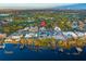 An aerial view of the property, surrounding neighborhood, lake and golf course at 7017 Via Carmel Way, Orlando, FL 32819