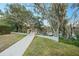 Picturesque backyard with a wooden walkway leading to the waterfront at 7017 Via Carmel Way, Orlando, FL 32819