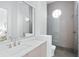Modern bathroom featuring a vessel sink vanity and glass enclosed shower with a round window at 7017 Via Carmel Way, Orlando, FL 32819