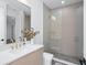 Modern bathroom with frameless glass shower, sleek vanity, and gold fixtures at 7017 Via Carmel Way, Orlando, FL 32819