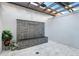 An open air courtyard with a stone accent wall, fountain and a pergola at 7017 Via Carmel Way, Orlando, FL 32819