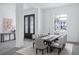 Dining room with natural light, seating for eight, and view of the exterior at 7017 Via Carmel Way, Orlando, FL 32819