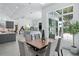 Elegant dining room with modern table, chairs, and natural light, adjacent to kitchen at 7017 Via Carmel Way, Orlando, FL 32819