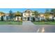 Stunning two-story home boasts a balcony, lush landscaping, and a grand brick driveway at 7017 Via Carmel Way, Orlando, FL 32819