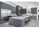 The modern kitchen features a spacious island with seating and sleek, stainless steel appliances at 7017 Via Carmel Way, Orlando, FL 32819
