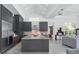 Bright, open kitchen featuring a large island, stainless steel appliances, and modern gray cabinets at 7017 Via Carmel Way, Orlando, FL 32819