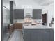Contemporary kitchen with gray cabinets, quartz counters, and stainless steel appliances at 7017 Via Carmel Way, Orlando, FL 32819