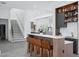 Open-concept kitchen with bar seating, modern appliances, and seamless flow to living areas and second floor at 7017 Via Carmel Way, Orlando, FL 32819