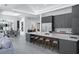 Modern kitchen with gray cabinets, large island, and seating for casual dining at 7017 Via Carmel Way, Orlando, FL 32819