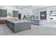 Open-concept kitchen features a large island, modern appliances, and seamless flow to the living area at 7017 Via Carmel Way, Orlando, FL 32819