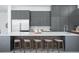 The kitchen's large island provides ample seating, complemented by modern gray cabinets at 7017 Via Carmel Way, Orlando, FL 32819